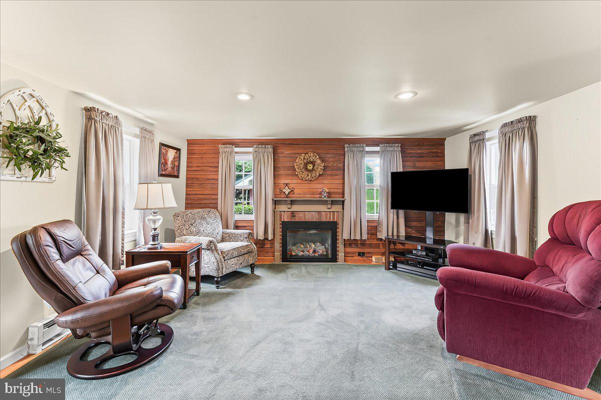 1439 Middletown Road Glen Mills, PA 19342 - Photo 6 of 45 a living room with furniture a fireplace and a flat screen tv