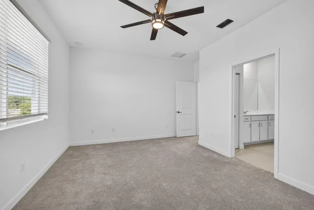 a view of a livingroom with a ceiling fan and window