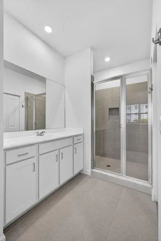 a spacious bathroom with a shower and a sink