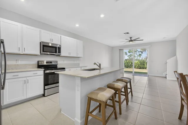 a kitchen with a sink cabinets and window