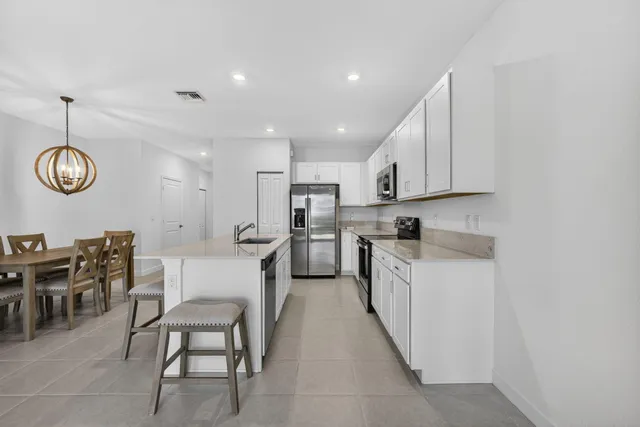 a kitchen with a sink cabinets and stainless steel appliances