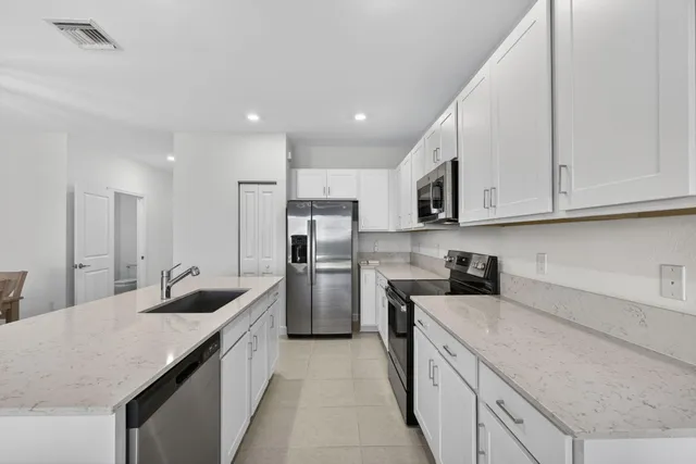 a kitchen with refrigerator and cabinets