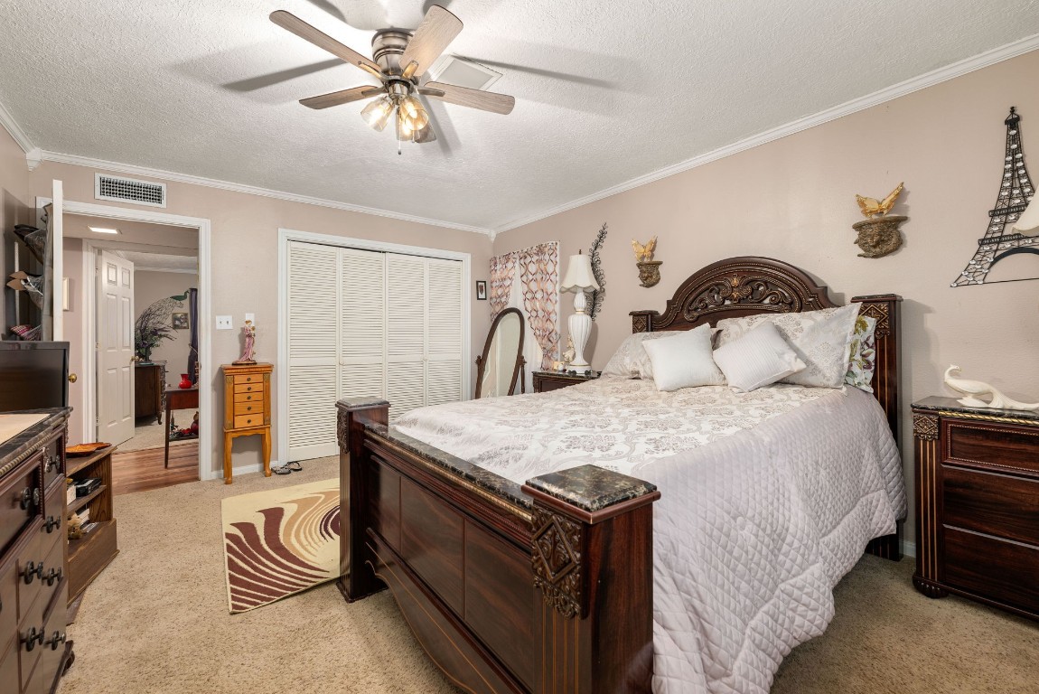 1811 Myrtle Street Liberty, TX 77575 - Photo 11 of 18 a bedroom with a bed and a chandelier