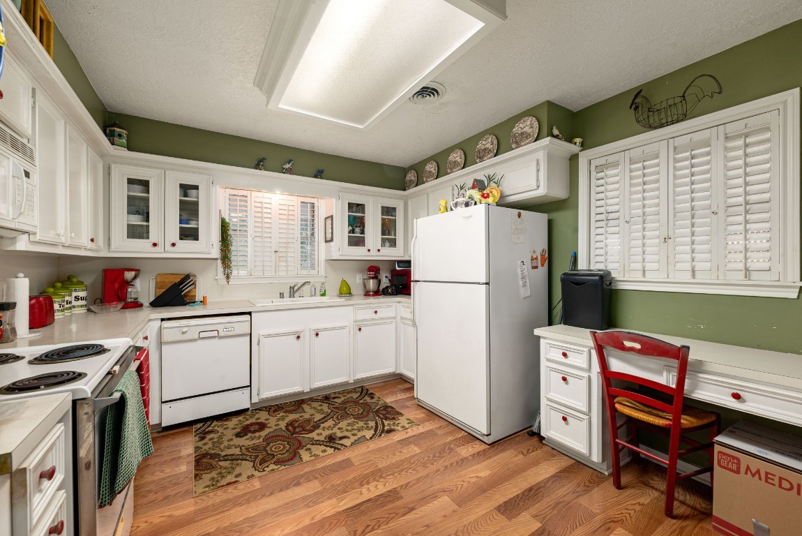 1811 Myrtle Street Liberty, TX 77575 - Photo 5 of 18 a kitchen with a refrigerator and wooden cabinets