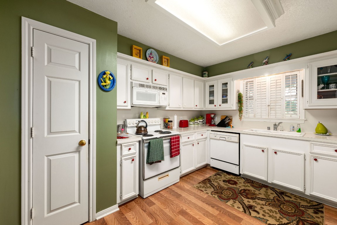 1811 Myrtle Street Liberty, TX 77575 - Photo 6 of 18 a kitchen with a white cabinets stove and sink