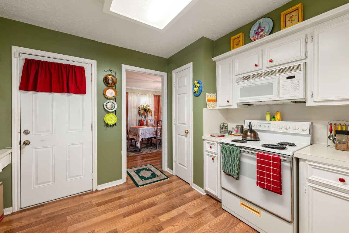1811 Myrtle Street Liberty, TX 77575 - Photo 7 of 18 a kitchen that has a lot of cabinets a sink and appliances in it