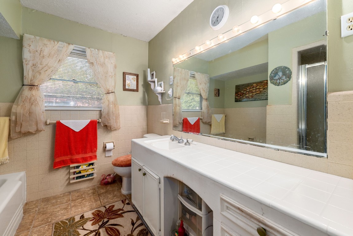 1811 Myrtle Street Liberty, TX 77575 - Photo 8 of 18 a bathroom with a sink vanity mirror and toilet