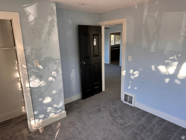 154 East Harris Street Ogden, UT 84401 - Photo 10 of 10 Unfurnished bedroom with dark carpet and a textured ceiling