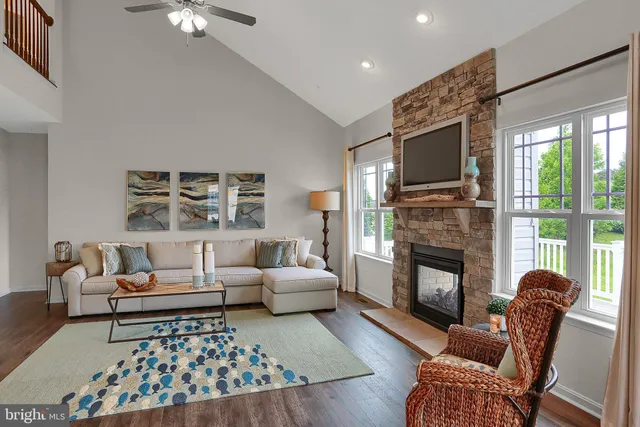 a living room with furniture fireplace and window