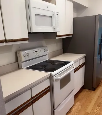 an empty room with a window and a ceiling fan