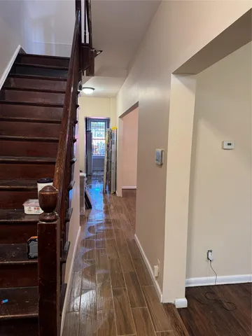 a view of staircase with railing and white walls