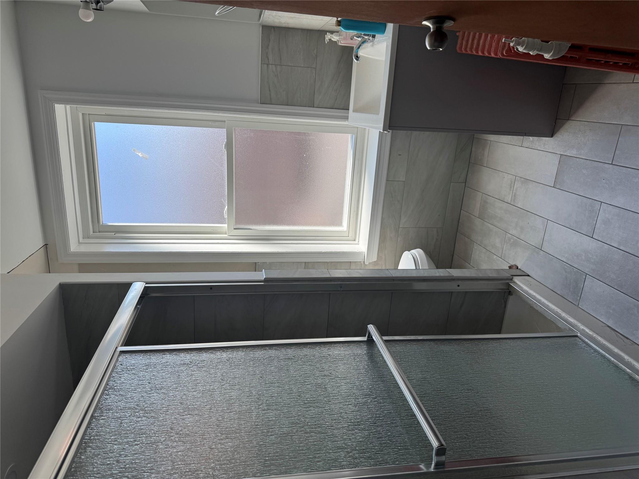 776 Hewitt Place Bronx, NY 10455 - Photo 5 of 20 a bathroom with a bathtub and a shower