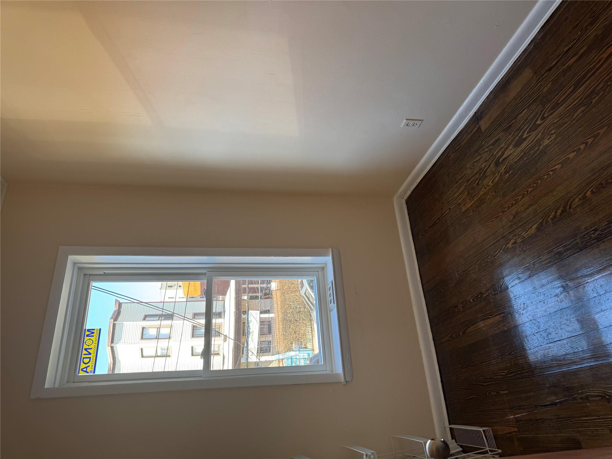 776 Hewitt Place Bronx, NY 10455 - Photo 7 of 20 a view of an empty room with wooden floor and a window