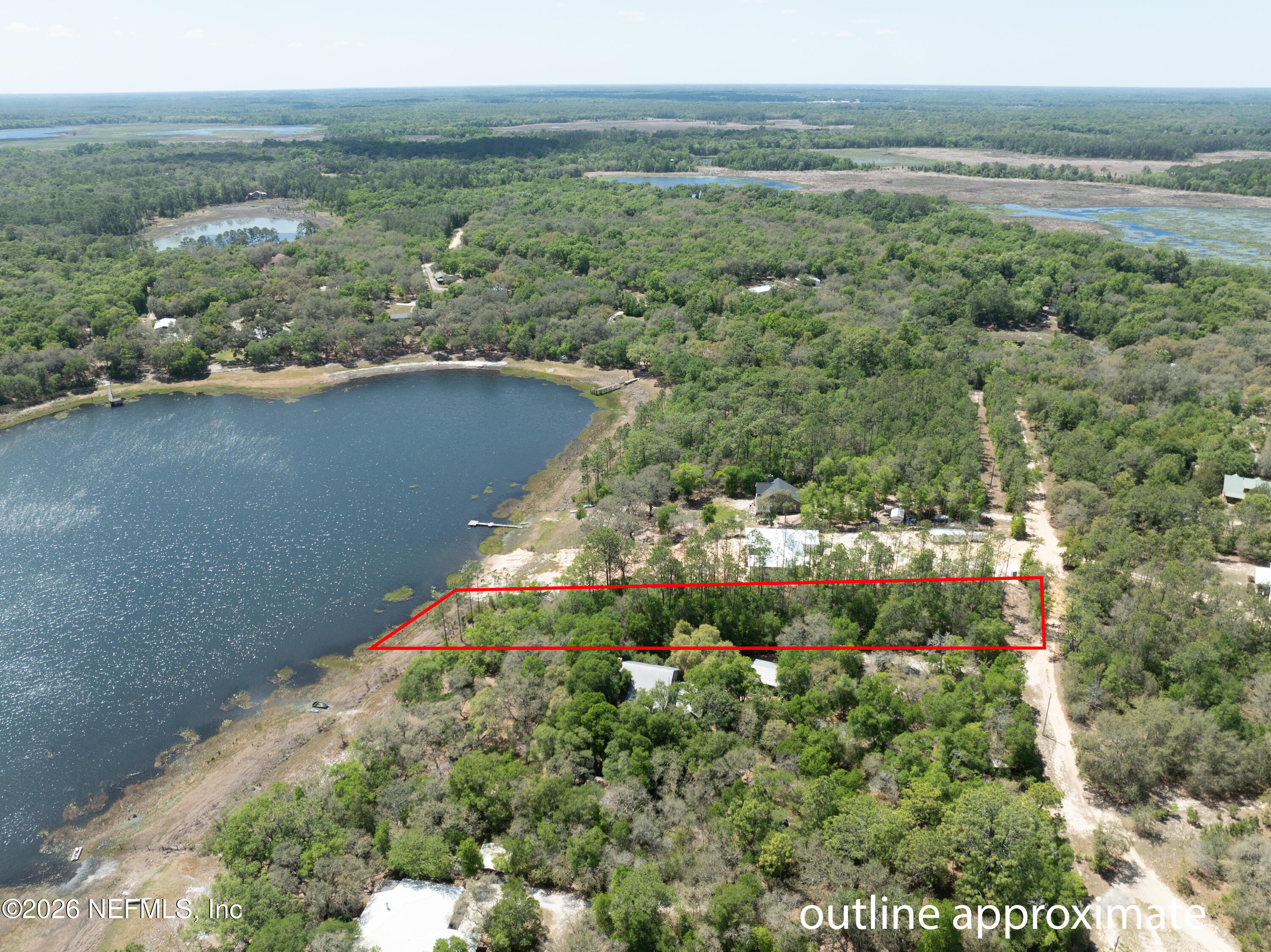 111 Gator Trail Melrose, FL 32666 - Photo 1 of 11 a view of a lake with a yard