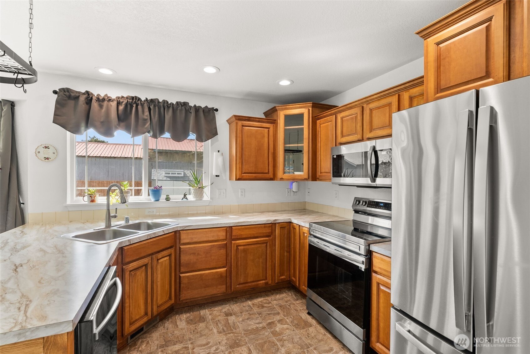 1231 Southwest Elzina Street Chehalis, WA 98532 - Photo 12 of 24 a kitchen with stainless steel appliances granite countertop a sink and cabinets