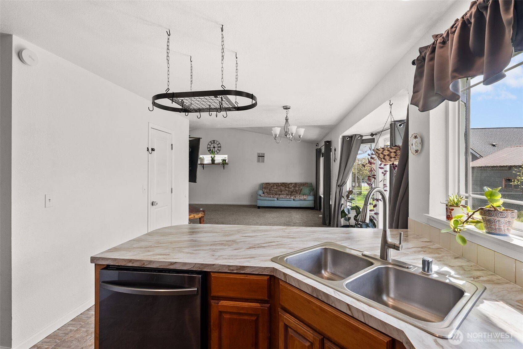 1231 Southwest Elzina Street Chehalis, WA 98532 - Photo 13 of 24 a kitchen with a sink a counter space and a chandelier
