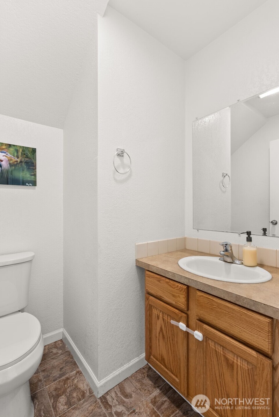 1231 Southwest Elzina Street Chehalis, WA 98532 - Photo 14 of 24 a bathroom with a granite countertop sink a toilet and a mirror