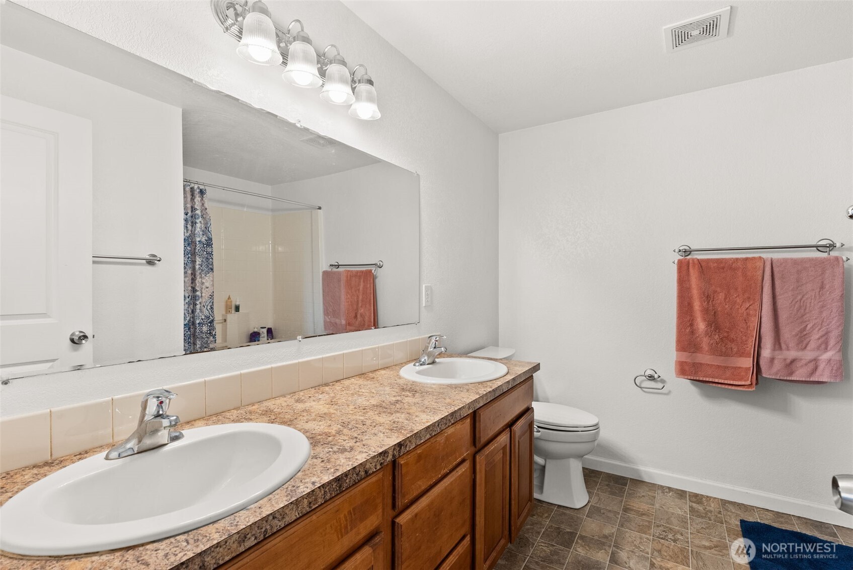 1231 Southwest Elzina Street Chehalis, WA 98532 - Photo 16 of 24 a bathroom with a granite countertop sink a toilet and a mirror