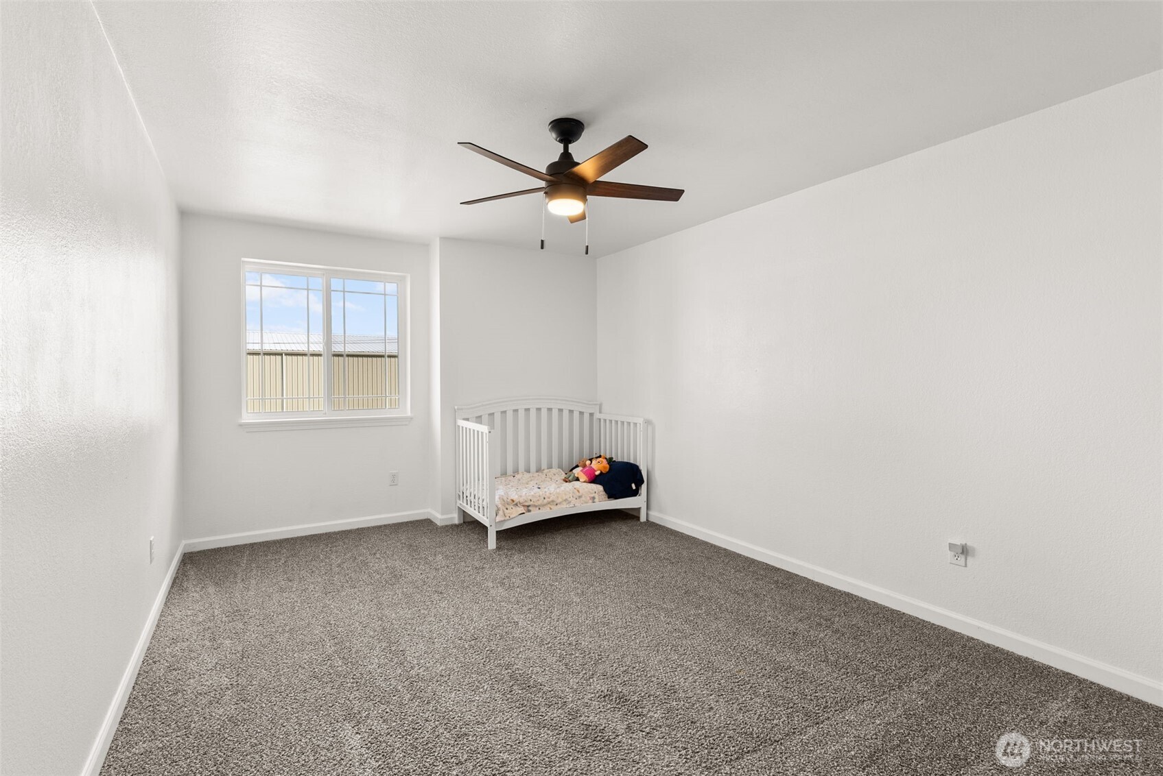1231 Southwest Elzina Street Chehalis, WA 98532 - Photo 17 of 24 an empty room with windows and fan