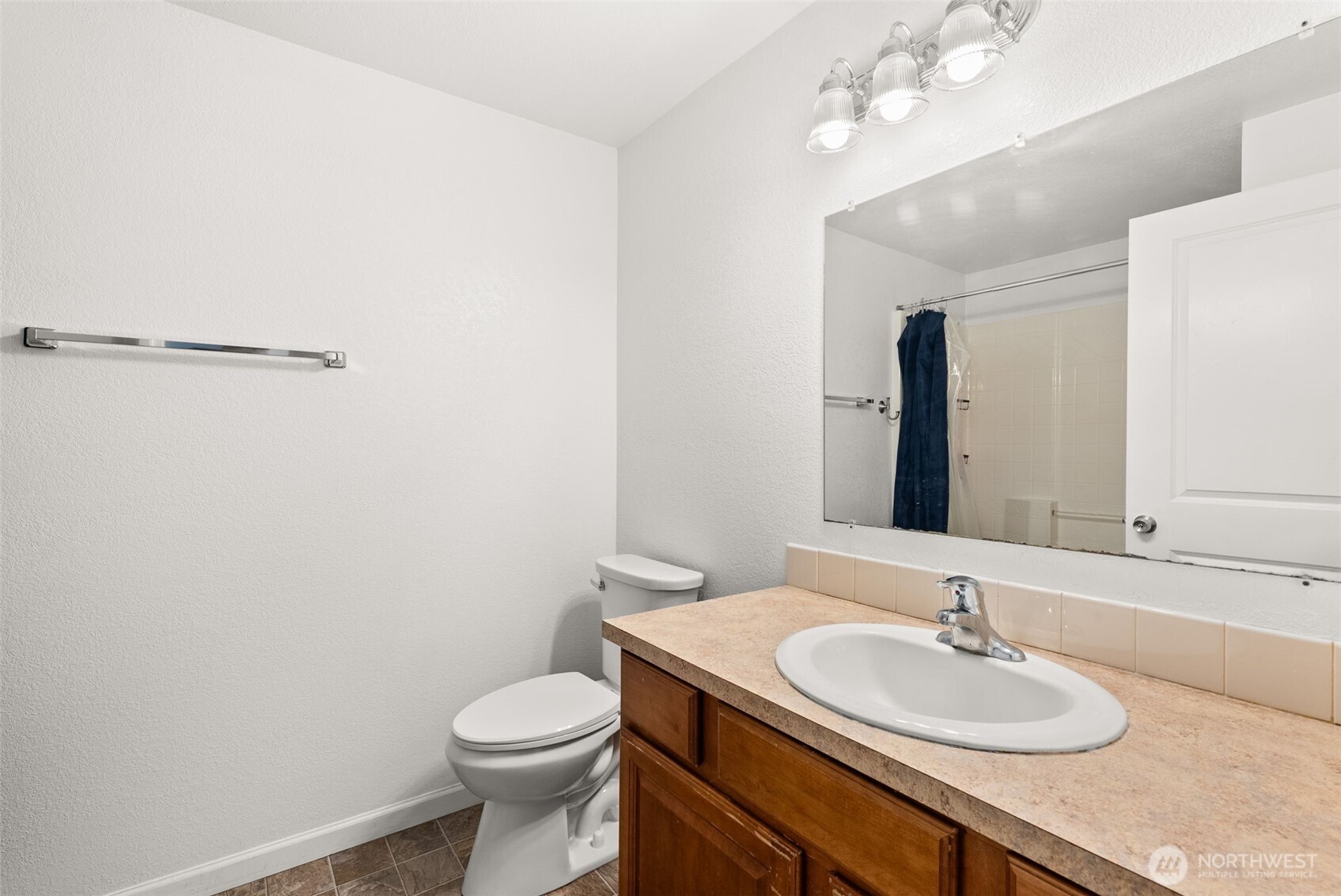 1231 Southwest Elzina Street Chehalis, WA 98532 - Photo 18 of 24 a bathroom with a sink a toilet and mirror