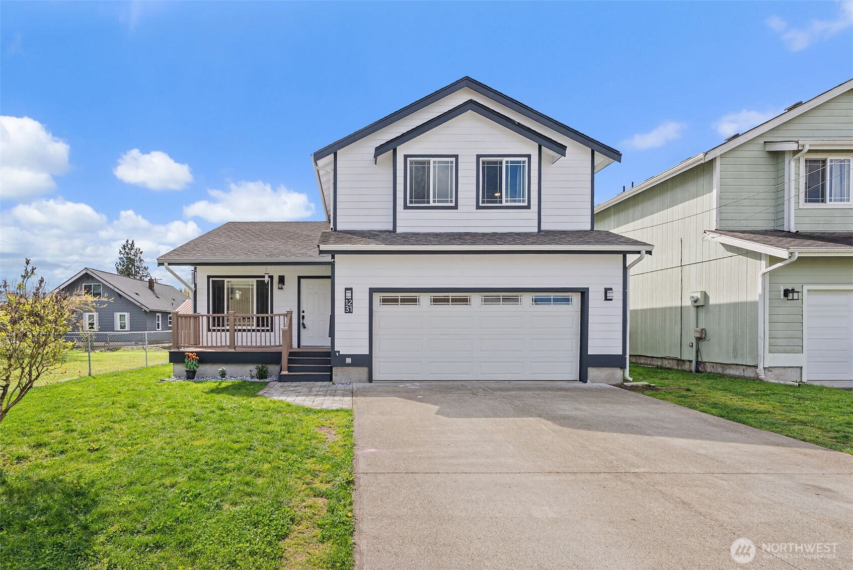1231 Southwest Elzina Street Chehalis, WA 98532 - Photo 2 of 24 a front view of a house with a garden and plants