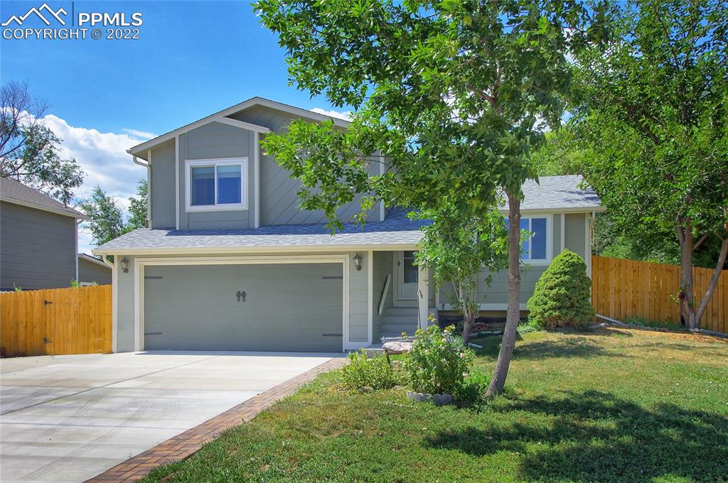 541 Blossom Field Road Fountain, CO 80817 - Photo 1 of 30 a front view of a house with a yard and garage