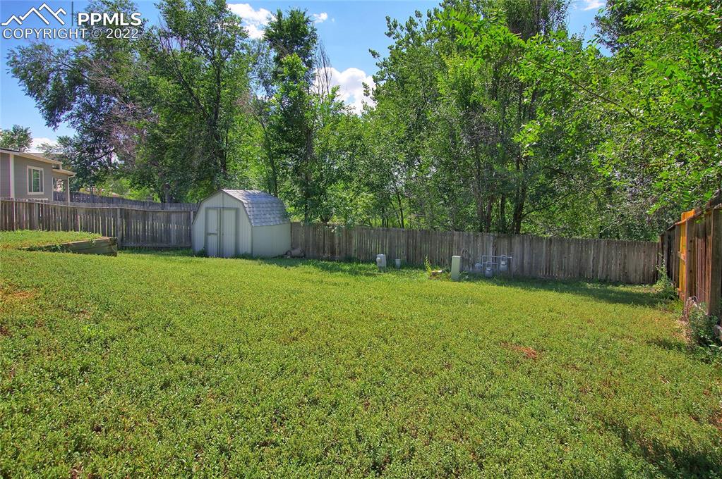 541 Blossom Field Road Fountain, CO 80817 - Photo 26 of 30 a swimming pool with wooden fence