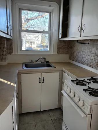 a kitchen with a stove and a sink