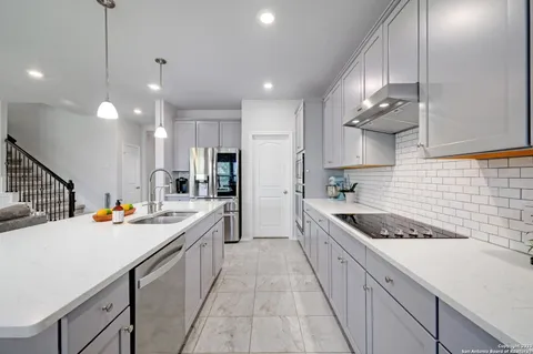 a kitchen with a sink stove and cabinets