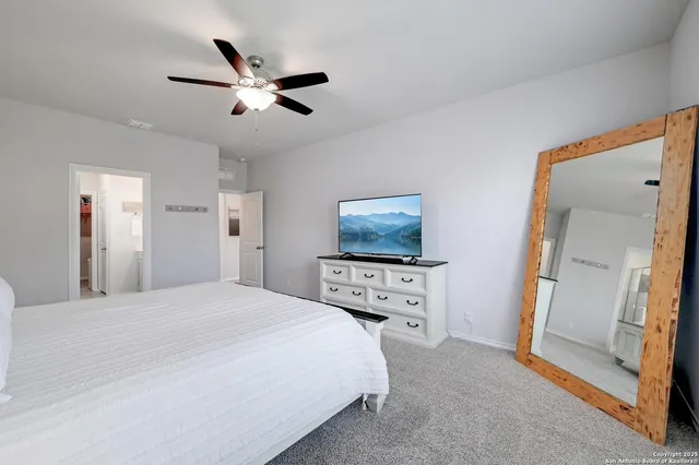 a bedroom with a bed and a tv