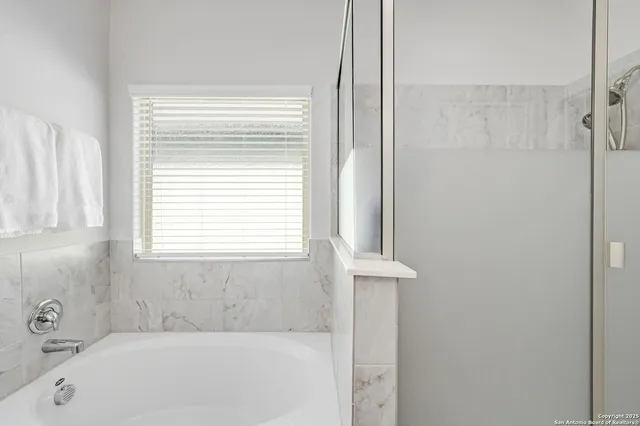 a white bath tub sitting next to a window