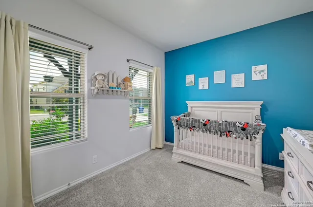 a bedroom with furniture and a window
