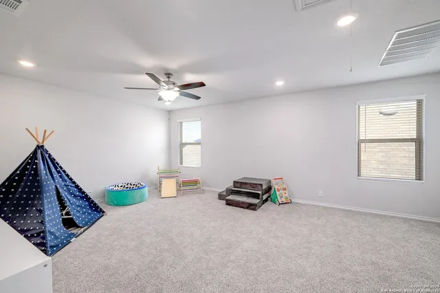 a view of a livingroom with a ceiling fan and window