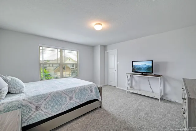 a bedroom with a bed and lamp