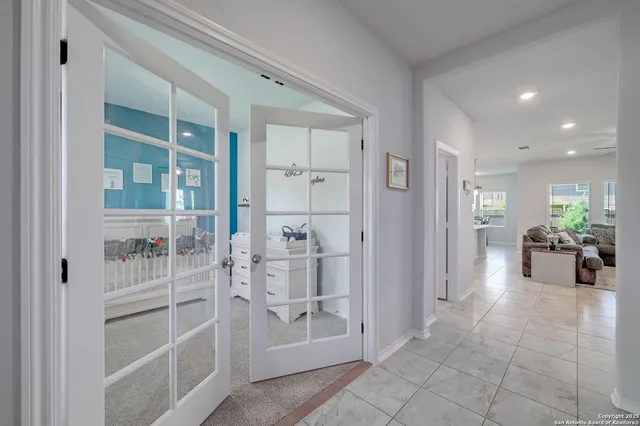 a lobby with furniture and a glass door shower