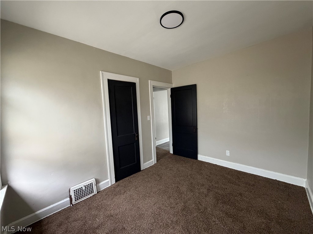 15317 Shiloh Road Cleveland, OH 44110 - Photo 21 of 29 Interior room featuring brown carpet flooring, light neutral-toned walls, and white baseboards
