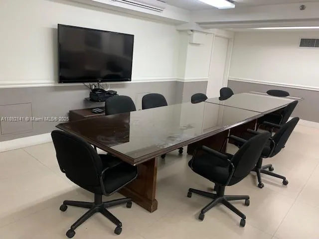 a living room with furniture and a view of kitchen