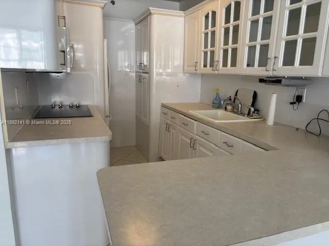 a kitchen with stainless steel appliances granite countertop a refrigerator a stove and a sink