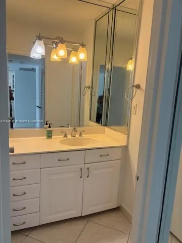 a bathroom with a double vanity sink and mirror