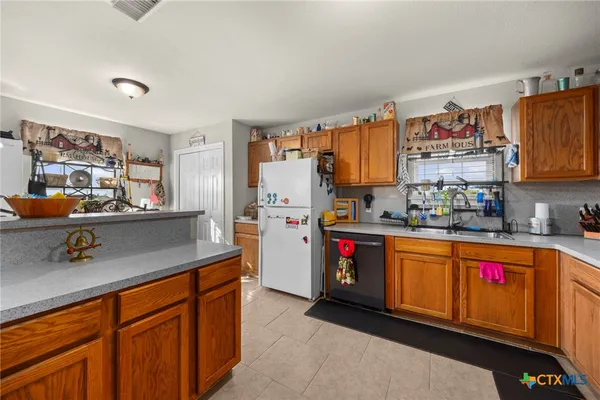 a kitchen with stainless steel appliances granite countertop a sink a stove and a refrigerator