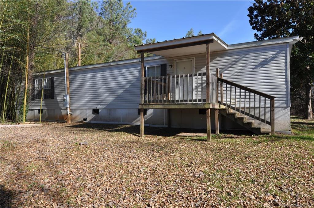 1585 Ashford Road, Unit 2B Chester, SC 29706 - Photo 1 of 15 a backyard of a house with large trees and wooden fence