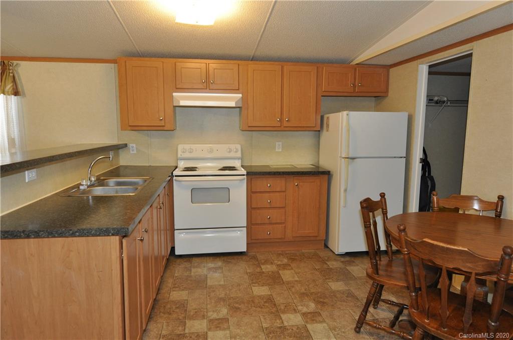 1585 Ashford Road, Unit 2B Chester, SC 29706 - Photo 12 of 15 a kitchen with a stove a refrigerator and a table