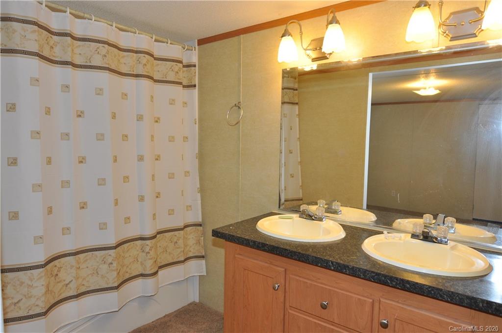 1585 Ashford Road, Unit 2B Chester, SC 29706 - Photo 6 of 15 a bathroom with a double vanity sink and a mirror