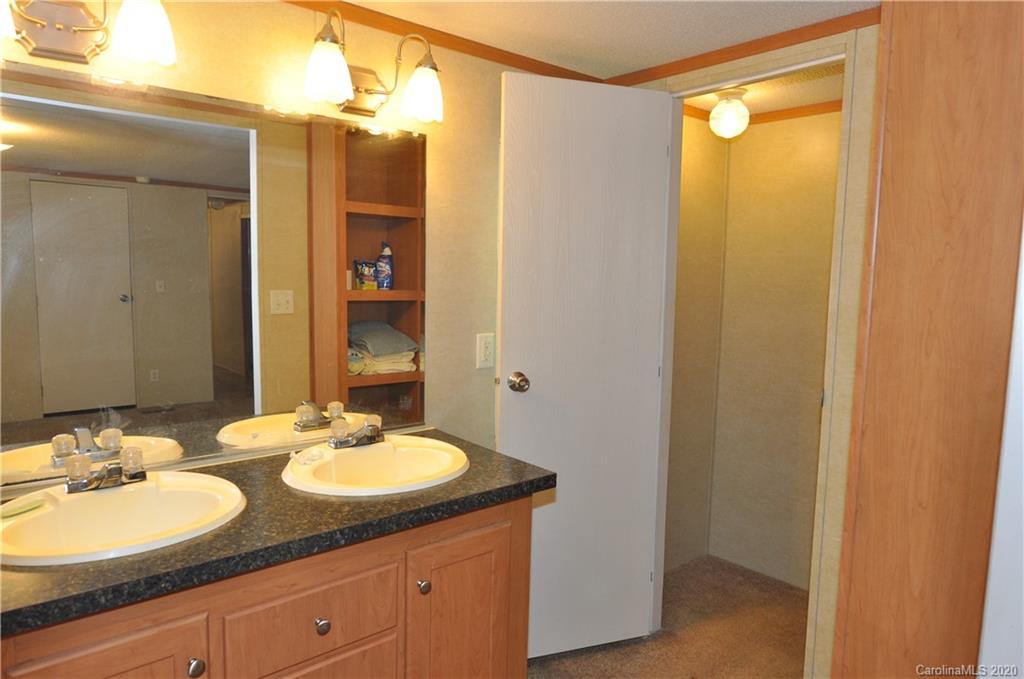 1585 Ashford Road, Unit 2B Chester, SC 29706 - Photo 7 of 15 a bathroom with a granite countertop sink and a mirror