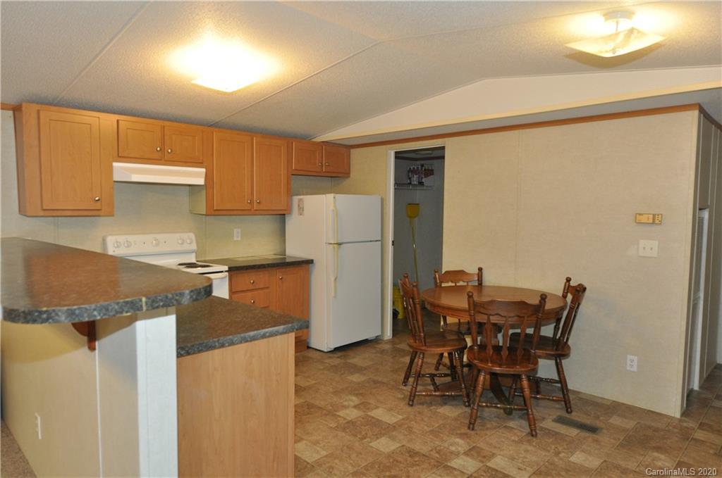 1585 Ashford Road, Unit 2B Chester, SC 29706 - Photo 10 of 15 a kitchen with stainless steel appliances granite countertop a refrigerator and a stove top oven