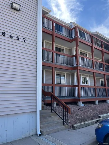 a view of a brick house with many windows