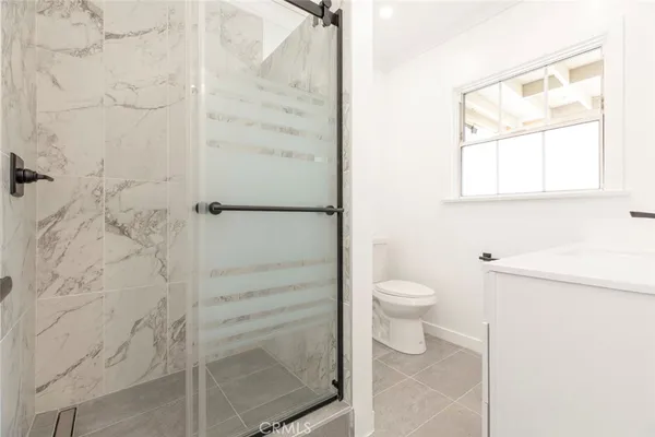 a bathroom with a toilet and a shower