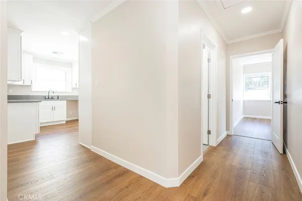 a view of a hallway with wooden floor