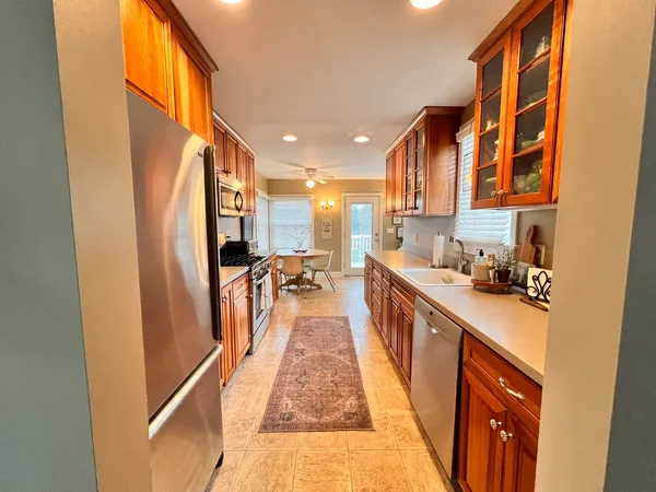 a kitchen with stainless steel appliances granite countertop lots of counter top space and wooden floor