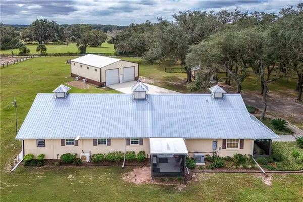 a aerial view of a house with swimming pool and a yard